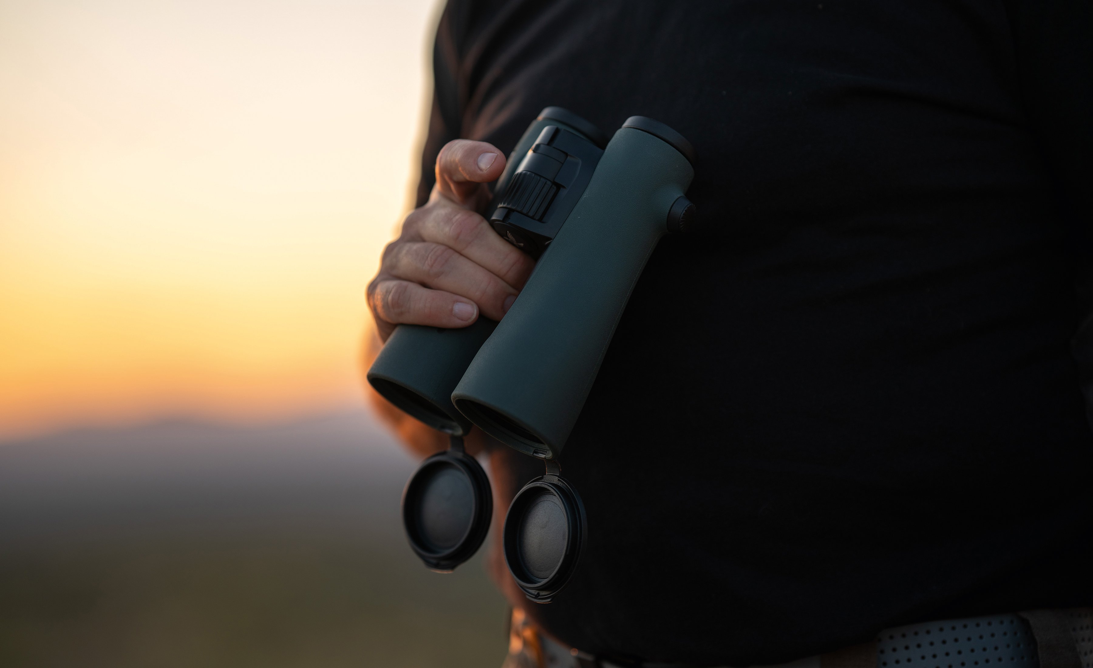 Person using Swarovski Optik binoculars